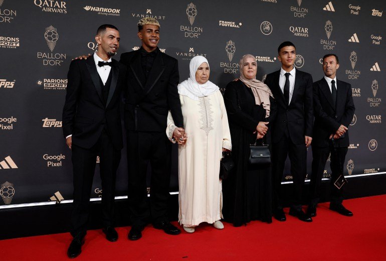 Soccer Football - Ballon d'Or - Arrivals - Theatre du Chatelet, Paris, France - September 22, 2025 FC Barcelona's Lamine Yamal, his father Mounir Nasraoui, his grandfmother Fatima, and other family members pose for a photo REUTERS/Benoit Tessier